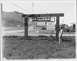 Sign post listing service and fraternal organization meeting times, Petaluma, California, about 1949