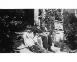 Walter Neil sitting on the front porch at 231 Wilson Street, Petaluma, California with his daughter, niece and nephew, about 1929