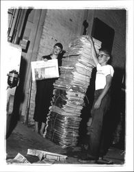 Betsy Olmsted Ashman and a boy with a large stack of Argus Courier centennial editions, Petaluma, California, 1955