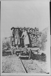 Three women on a flat car