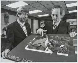 Lawrence Simons architects looking at model of Northern California Savings