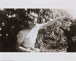 Mary McGregor playing with a dog, Santa Rosa, California, 1940