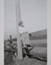 Zana Mildred Taylor Weaver sits on a fence, Sonoma County, California, 1900s