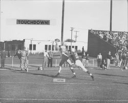 Halfback Ples Crews catches a touchdown pass in 33-7 Egg Bowl victory over Hamilton Air Force Base, Petaluma, California, Nov. 23, 1952