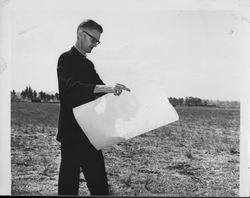 Father Charles O'Leary checking the blueprints for Saint James church, Petaluma, California, September 1964