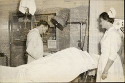 Unidentified Petaluma (California) General Hospital staff members administering to a patient, about 1940