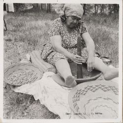 Elsie Allen pounding acorns into flour