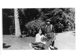 Molly Utz being taken for a wheel barrow ride by Venancio Gianicchini, Guerneville, California, 1922