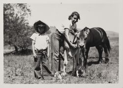 Posing with Jersey calf at the Sonoma County Fair, Santa Rosa, California, 1937