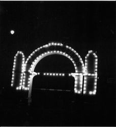 Sonoma County Fairgrounds entrance gate at night illuminated by strands of electric lights, about 1945