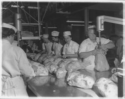 Workers bagging chickens at the California Poultry, Incorporated, Fulton, California, 1958