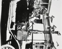 Two unidentified men in a Petaluma Cooperative Creamery vehicle parked in front of a home located on Western Avenue, between Baker and Upham Streets, about 1924