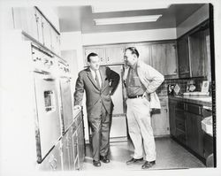 Lewis Meyers and unidentified man inspecting a Meyers built home, Santa Rosa, California, 1960