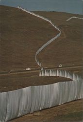 Christo's Running Fence crosses the busy Petaluma Valley Ford Road between segments 15 and 16, Bloomfield, California, September, 1976