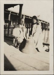 Two people and an old bell on the Old Adobe balcony, Petaluma, California, Dec. 4, 1929