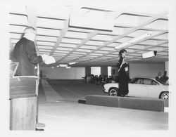 Black evening dress modeled in a fashion show at dedication of parking garage at 3rd and D, Santa Rosa, California, 1964