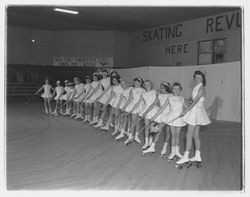Line of roller skaters with magic wands at the Skating Revue of 1957, Santa Rosa, California, April, 1957