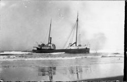 Unidentified ship aground near an unidentified beach, about 1900