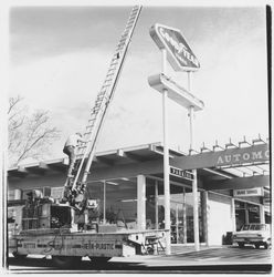 Santa Rosa Neon Lite Company erecting a sign for Downey Tire Company, Santa Rosa, California, 1971