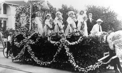 Children dressed as a bridal party atop a float