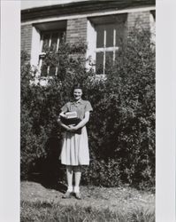 Mary Margaret Thompson standing in front of a building at Santa Rosa High School, Santa Rosa, California, about 1941