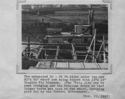 Dredge "Palo Alto" dredging the Petaluma River alongside a Poultry Producers of Central California wharf that is under construction , 1937