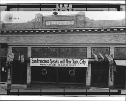 Pacific Telephone and Telegraph building, Petaluma, California, 1949, with sign proclaiming that "San Francisco Speaks with New York City Distance 3,400 miles"