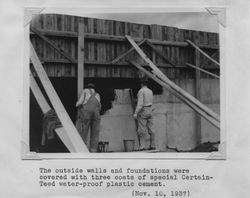 Two men working on the foundation of the Poultry Producers of Central California grain elevator at 323 East Washington Street, Petaluma, California. , 1937