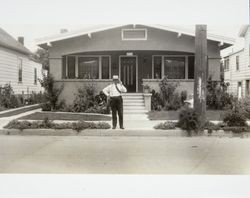 Ambrose Perotta standing in front of his residence in Santa Rosa, California, about 1930