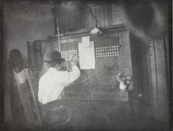 Tom Hoskins at the first telephone switchboard in Petaluma, California, 1884