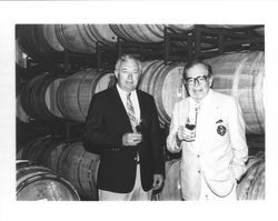 Allan Hemphill and Ed Gauer standing among wine barrels in , Alexander Valley, Sonoma County, California