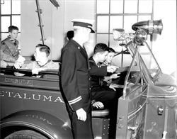 Chief James Eaglin and Boy Scouts examining a fire engine, Petaluma, California, about 1960