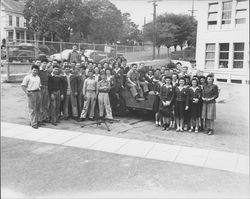 Students from St. Vincent's School posing with a jeep and machine gun, Petaluma, California, 1942