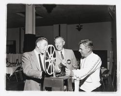 Babe Wood and two men setting up a projector for a Rotary Club meeting, Santa Rosa, California, 1962