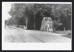 Girls beside a large redwood stump at the entrance to Guernewood Park