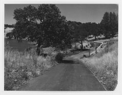 Earth-sheltered building next to an unidentified reservoir, 1960s or 1970s