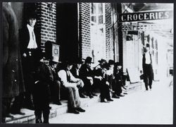 Group of men sitting on front steps of the post office