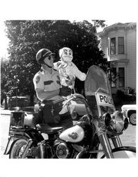 Carol Stockbenger in costume and a Petaluma police officer on his motorcycle, Petaluma, California, about 1963