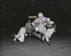 Run play during Petaluma Leghorn game against an unidentified team