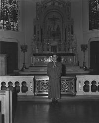 Altar boy in front of St. Vincent de Paul Church altar, Petaluma, California, about 1967