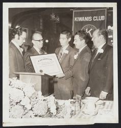 Tom Miller, president of the newly formed Kiwanis Club of Sebastopol, accepts the club's charter from Mark Alexander