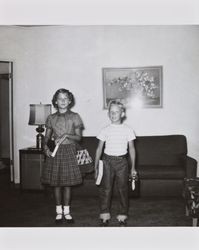 Bonnie and Bill Alwes standing with school supplies, 815 Beaver Street, Santa Rosa, California, about 1954