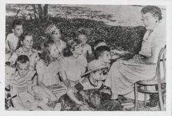 Librarian Dagny Juell conducting story-telling on the lawn behind the Santa Rosa Library