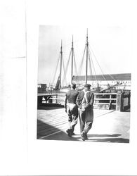 Men walking along the waterfront toward the schooner C.A. Thayer, San Francisco, California, about 1930