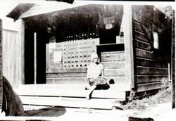 Unidentified woman sitting on the steps of the Occidental Post Office, Occidental, California, about 1927