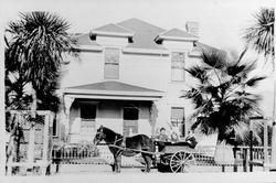 Children sitting in a cart in front of the home of George M. Bosworth, Geyserville, California, about 1900