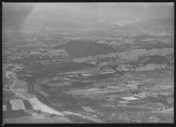 Aerial view of the Russian River facing north. Fitch Mountain is at the center with Northwestern Pacific railroad and the Redwood highway (101)--Healdsburg is to the left of Fitch Mountain, photographed between 1950 and 1962