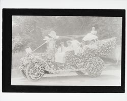 Rose Carnival entry of a car decorated with flowers and butterflies