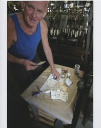 Harold Allen looking up while holding a piece of paper, Sunset Line & Twine, Petaluma, California, Dec. 2006