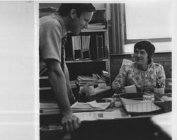 Don Gass and Linda Haering talking in the office at the Petaluma Carnegie Library, 1975